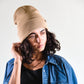 Side profile view of The Lucks Beanie in tan. FallenBROKENstreet wool blend ribbed knit beanie with folded cuff and signature logo detail. A versatile unisex accessory that offers warmth, comfort, and understated style, perfect for layering during cooler months.