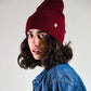 woman wearing Wine Lucks Beanie in soft wool blend, unisex design with ribbed knit and folded cuff.