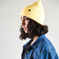 side view FallenBROKENstreet Lucks Beanie in Buttercup yellow, ribbed knit, flexible fit, signature logo badge.