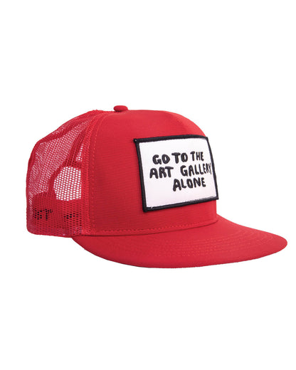 Side profile of the Art Gallery Cap Red from the FallenBROKENstreet x Marty Baptist range. The bold red foam front meets breathable mesh for airflow, with an embroidered patch carrying Marty Baptist’s handwritten text. A true fusion of functional fashion and contemporary street art. The hat includes an adjustable snapback strap and a flattering trucker silhouette. Pair it with casual festival wear or creative city looks. Designed for those who walk alone into galleries—and into life—with style.