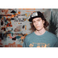 Model wearing Marty Baptist cap in front of a mural, casual and expressive look.