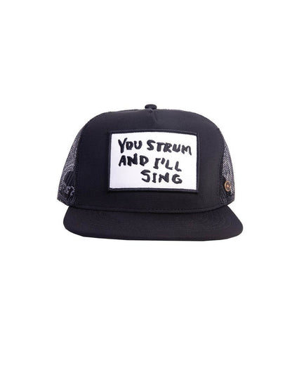 Straight view of black trucker cap showing patch text.