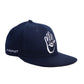 Side angle of the navy Miracle Eye Cap showing clean profile, structured wool paneling, and the embroidered Marty Baptist signature above the ear. The design reflects craftsmanship and subcultural influence.

