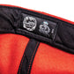 Close-up of inner label on Marty Baptist x FBS wool felt cap Limited edition hat in red with elastic back, embroidered signature, and premium construction.

