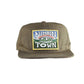 The Stash Cap – Canvas Nimbin with 10-panel cotton canvas build, custom “Nimbin Town” embroidered patch, and flat brim. Includes signature fallenBROKENstreet button and secret inner pocket.

