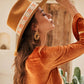 Lifestyle image of model smiling in FBS x Nine Lives wool felt hat, ideal for summer festivals and retro lovers

