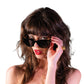 Fashion detail shot of black acetate sunglasses styled with gold earrings