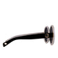 Close-up of black acetate and white contrast arm with gold hardware on Fallenbrokenstreet sunglasses


