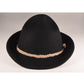 Black wool felt hat with a domed crown and a wide, curved brim. Features a braided rope band and subtle branded metal button detail. Styled alone on a grey backdrop to highlight the hat’s clean silhouette.

