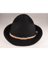 Black wool felt hat with a domed crown and a wide, curved brim. Features a braided rope band and subtle branded metal button detail. Styled alone on a grey backdrop to highlight the hat’s clean silhouette.

