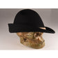 Side view of The Peter – Black felt hat displayed on a gold skull mannequin. Highlights the textured rope trim and bold curve of the brim.

