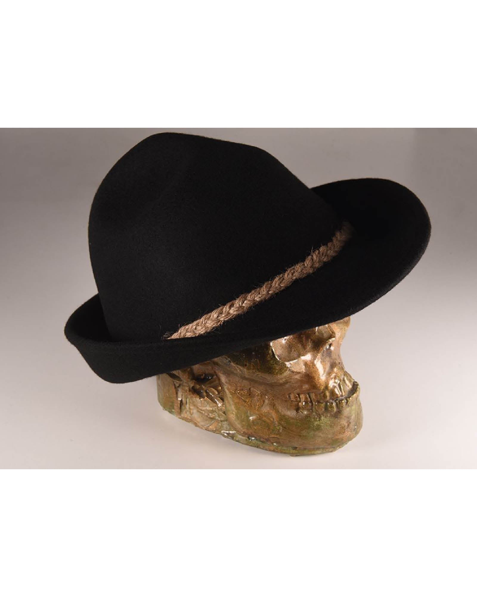 Angled shot of the black felt Peter hat on a sculptural skull, showcasing the depth of the crown and statement structure of the wide brim.

