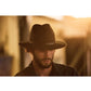 Model wearing The Crushable Ratatat Felt Hat – Mottle Brown. Australian wool felt fedora with leather band and soft, crushable structure.