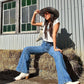 Women wearing Western cowgirl hat with cowboy boots on haybale