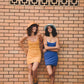Models side by side wearing Saturday Bucket Hat – Blue and Saturday Bucket Hat – Tangerine by FallenBROKENstreet. Wide brim cotton chenille summer hats with UPF 50+ sun protection, designed for playful festivals, coastal escapes, and relaxed weekend style.
