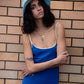Portrait shot of model wearing the Saturday Bucket Hat – Blue. Lightweight cotton chenille with wide brim, breathable cotton inner band, and UPF 50+ rating. A bright unisex summer essential for festivals, beach days, and streetwear styling.