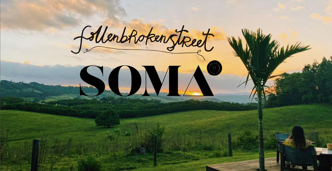 Fallenbrokenstreet x SOMA collection banner featuring a tropical sunrise over Byron Bay hinterland. Overlay text reads “Fallenbrokenstreet x SOMA,” symbolizing the mindful collaboration between the hatmaker and wellness retreat.
