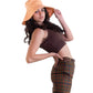 Model wearing The Sandbar peach linen bucket hat, styled with a brown crop top and patterned pants. The hat’s wide brim and natural drape offer a flattering silhouette while providing practical sun protection. A relaxed look for summer styling.


