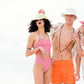 Lifestyle image of models at the beach, one wearing the Saturday Bucket Hat – White. Cotton chenille bucket hat with UPF 50+ rating, wide brim, and lightweight design. Perfect for unisex summer styling, festivals, and relaxed coastal wear.