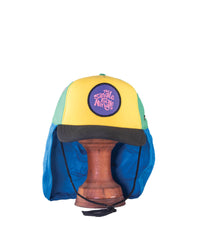 Front view on stand – Limited edition yellow, green, and blue surf cap on wooden stand with neck flap, FallenBROKENstreet collab.

