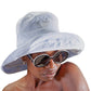 Woman wearing light blue Sunday Hat with oversized sunglasses, styled for relaxed summer days and festival vibes.