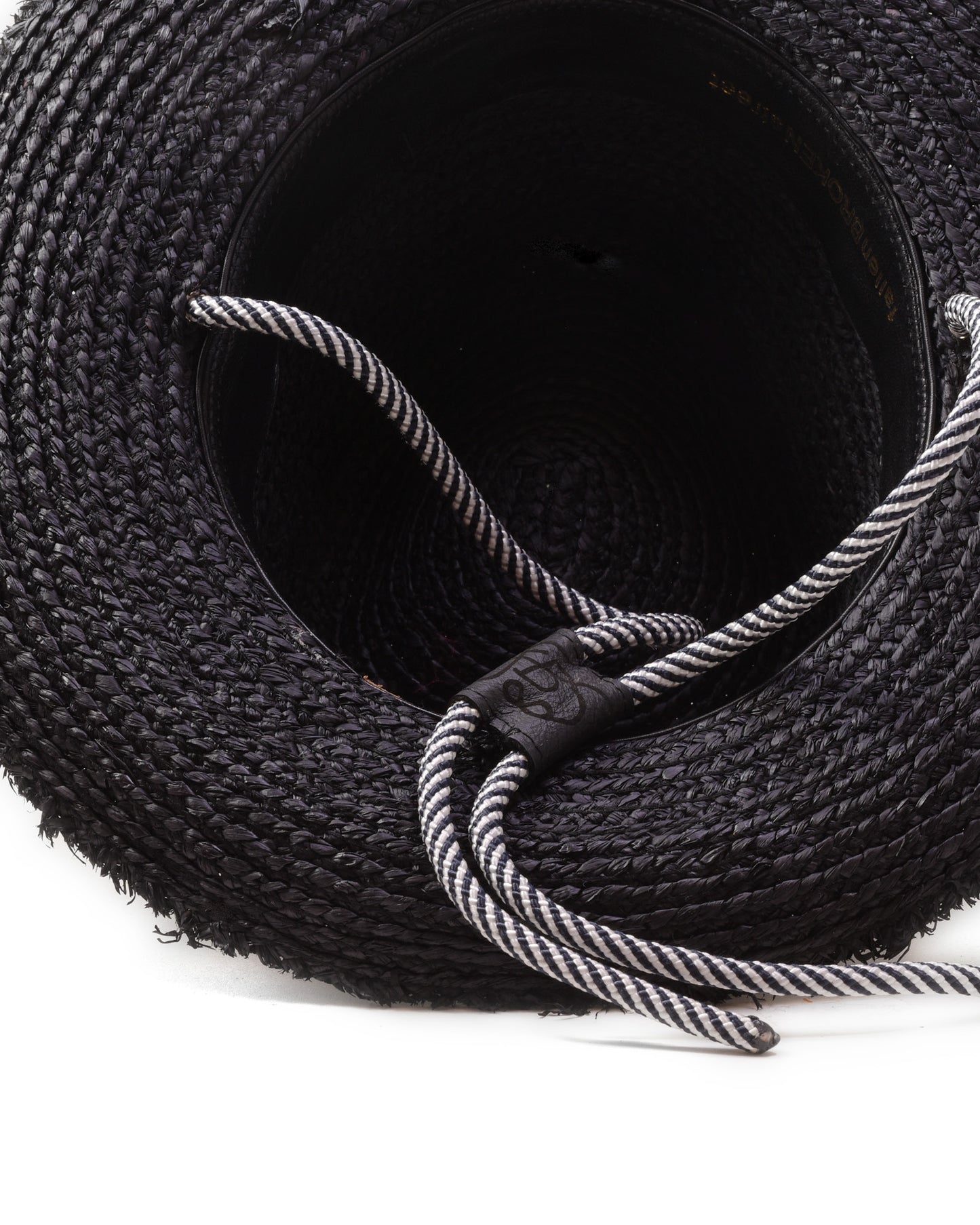 Inside closeup of FallenBROKENstreet Outrider Straw Hat – Black Raffia with frayed brim and cord tie.