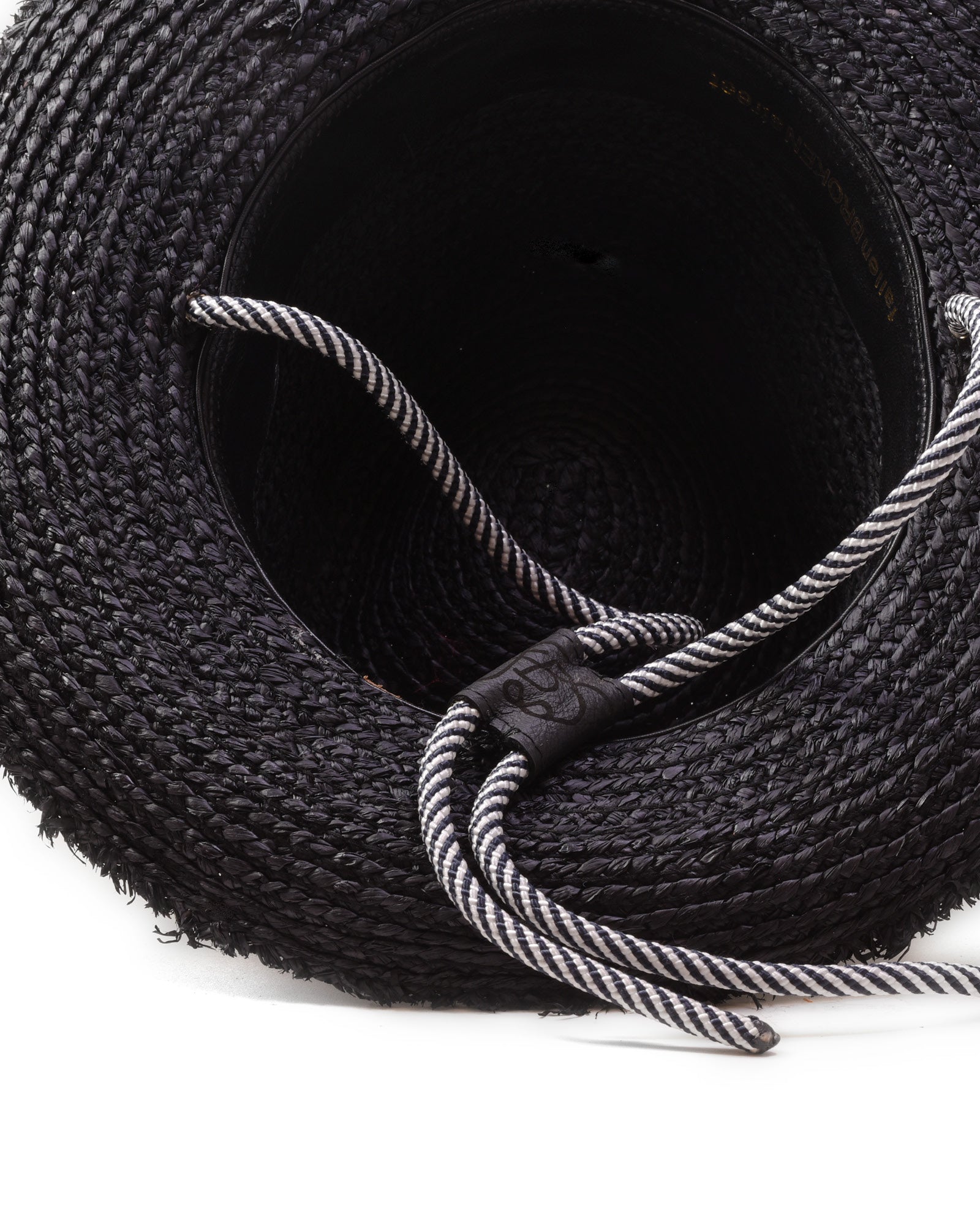 Inside closeup of FallenBROKENstreet Outrider Straw Hat – Black Raffia with frayed brim and cord tie.