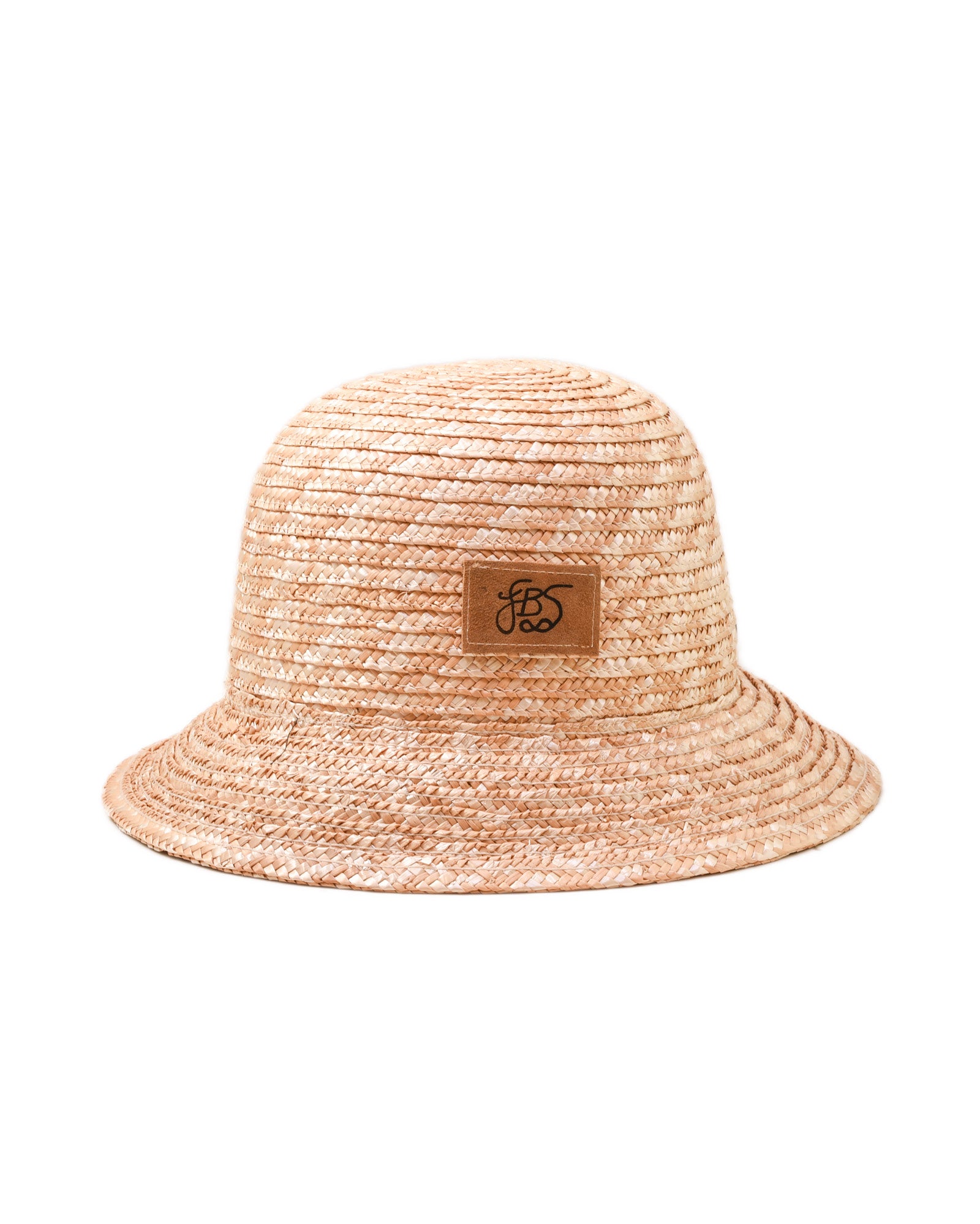 Beige straw bucket hat by fallenbrokenstreet with a brown leather patch on a white background 