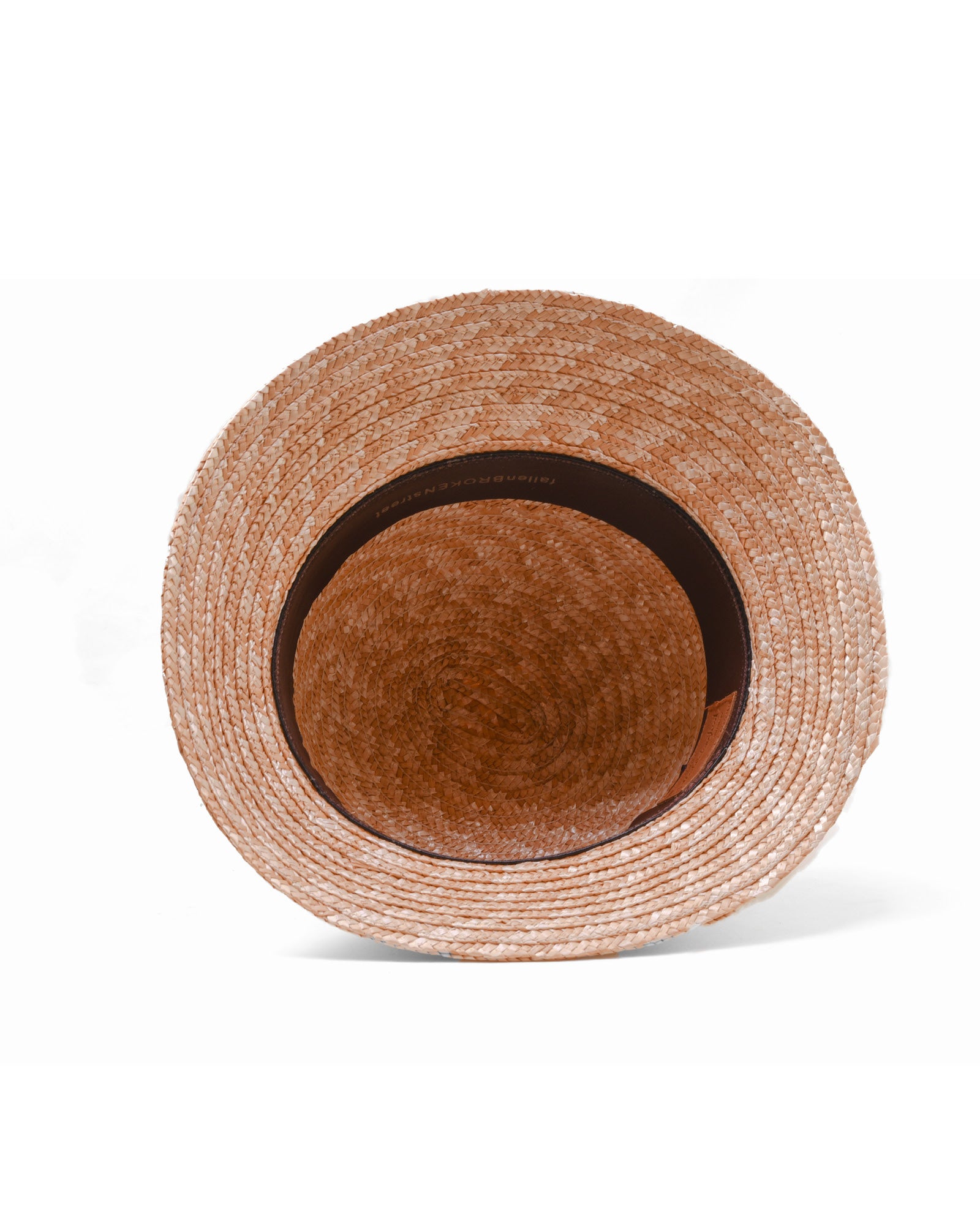 Inside of straw bucket hat by fallenbrokenstreet with a brown leather patch on a white background 