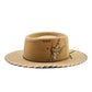 The Trailblazer Felt Hat by FallenBROKENstreet in camel wool felt. Wide brim with whipstitch detail, feather accent, leather inner band, and triple X embroidery. A rugged cowboy-inspired unisex hat with UPF 50+ protection, perfect for festivals and everyday wear.