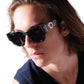 Editorial-style image of male model wearing THE COSMOS – Galaxy/Black sunglasses, showing how the shape frames the face. Strong lighting highlights polarised lenses and gold detailing. Perfect for unisex product presentation.

