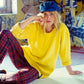 Model wearing The Original Kyte Cap – Light Indigo in artist studio setting. Relaxed, vintage-inspired denim style.