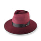Maroon fedora hat with a black band on a white background