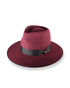 Maroon fedora hat with a black band on a white background