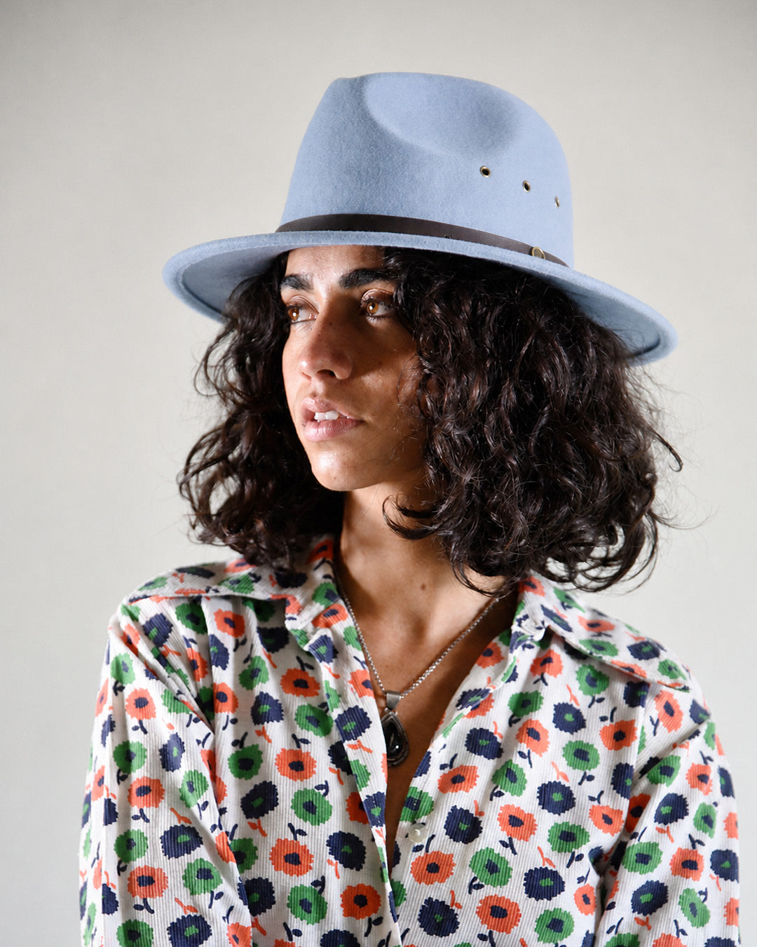 Woman wearing a babyblue felt hat