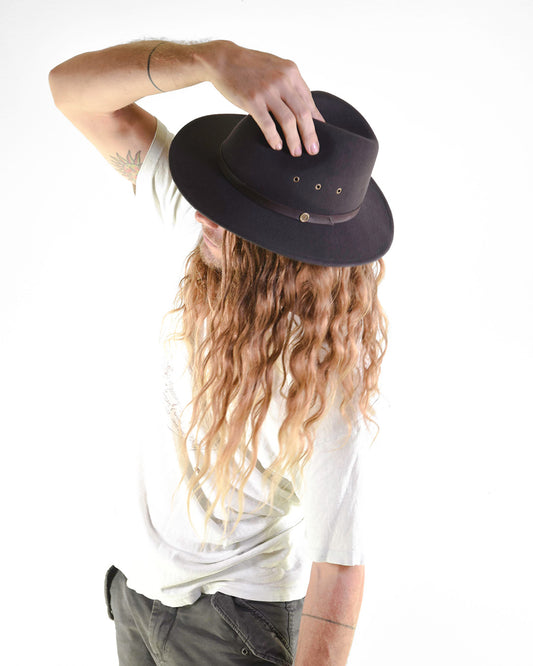 Person wearing a black hat with a white background