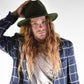 Man in a forest green wool felt hat and blue jacket