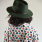 back view of woman in green fallenbrokenstreet wool hat