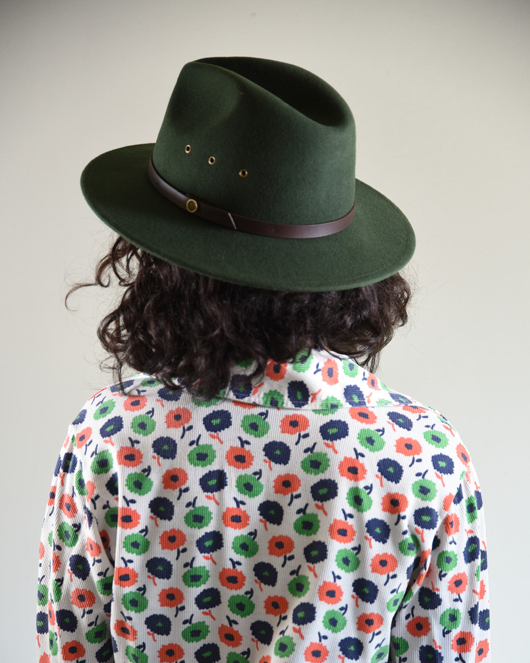 back view of woman in green fallenbrokenstreet wool hat