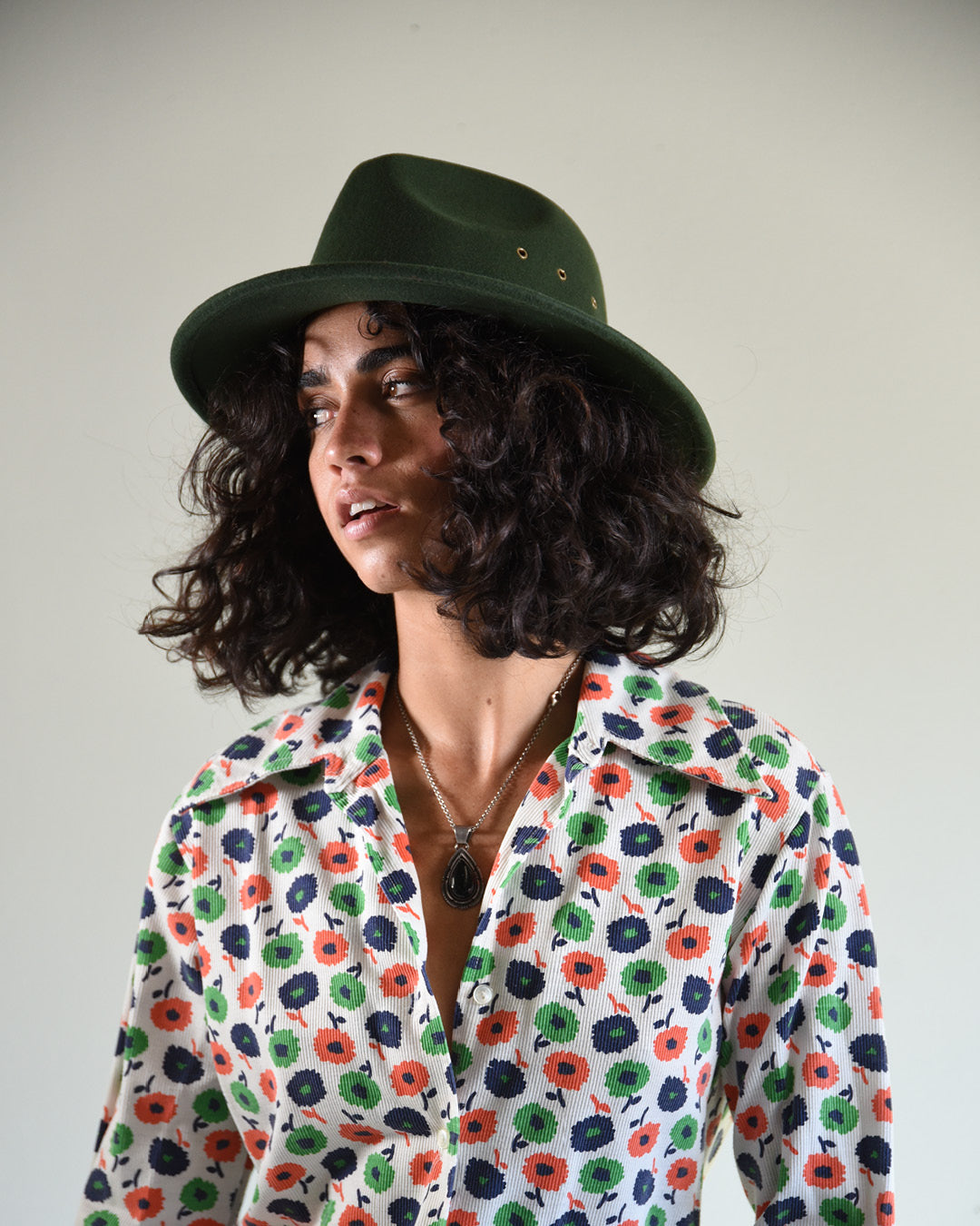 woman in a forest green wool felt hat