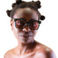 Model wearing THE SOLAR FLARE Galaxy sunglasses with pink lenses

