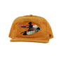 Front view of mustard corduroy cap with cockatoo feather embroidery on the crown

