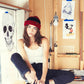 girl in art studio wears Red/Black Wally Beanie, cosy acrylic knit hat with pull-on closure.