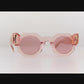 Video thumbnail of THE COSMOS – Pink/Pink sunglasses rotating on white surface, showing all angles of frame and lens tone.

