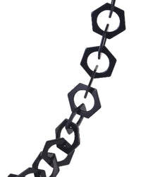Macro detail of the SUPERNATURAL Chain in matte black acetate from Fallenbrokenstreet. Features oversized hexagonal links, a bold minimalist look, and premium quality materials for stylish sunglass carrying.