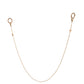 Button Chain in 24k gold laid flat to show its lobster clips, signature button charm, and premium finish. Lightweight, adaptable, and minimal in design.

