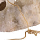 A detailed close-up of FallenBROKENstreet’s "Kill Them with Kindness" chain draped over a clear quartz crystal. The gold plating and scripted message are visible, showcasing the craftsmanship and meaning behind the accessory. Designed for style and spirit.

