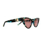 Side angle studio photo showing the profile of the cat-eye silhouette and shimmering pink lenses framed by galaxy acetate


