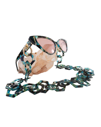 Studio image of the sunglasses being worn in a product video, demonstrating fit and pink CAT2 lens hue from a front-facing perspective

