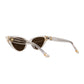 The Astral Plane sunglasses tilted at a 45-degree angle, showing off both the front and side. The clear acetate arms and cat-eye shape are enhanced by soft shadows.

